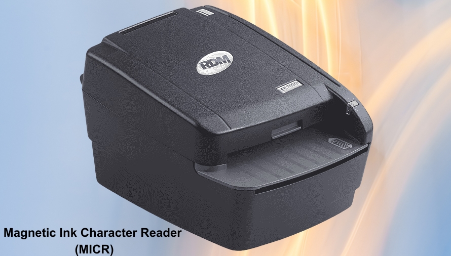 Black magnetic ink character reader (MICR) on a blue and orange gradient background. The device is compact with sleek design features.