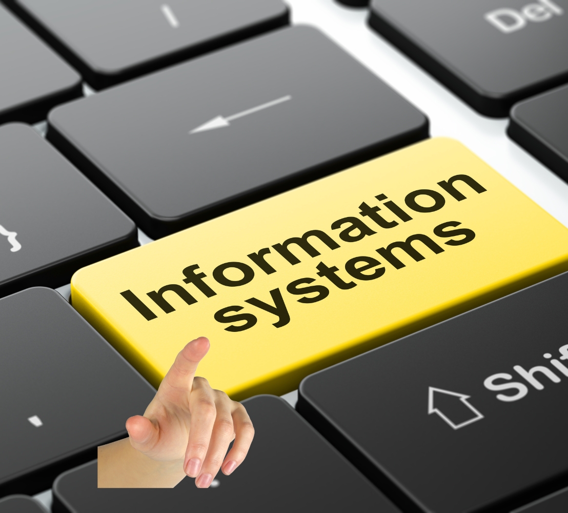 Close-up of a keyboard with a yellow key labeled "Information systems," surrounded by black keys. A hand is pointing towards the key, conveying a focus on IT or technology themes.